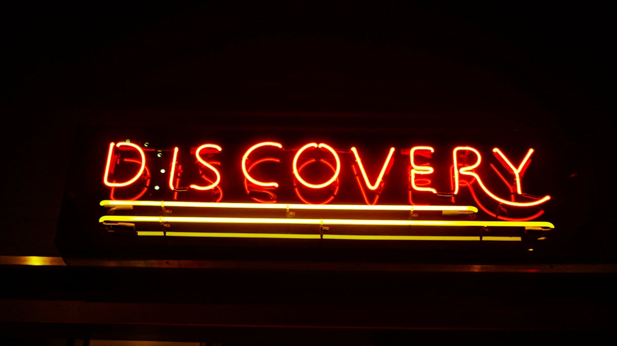 lighted red Discovery neon signage
