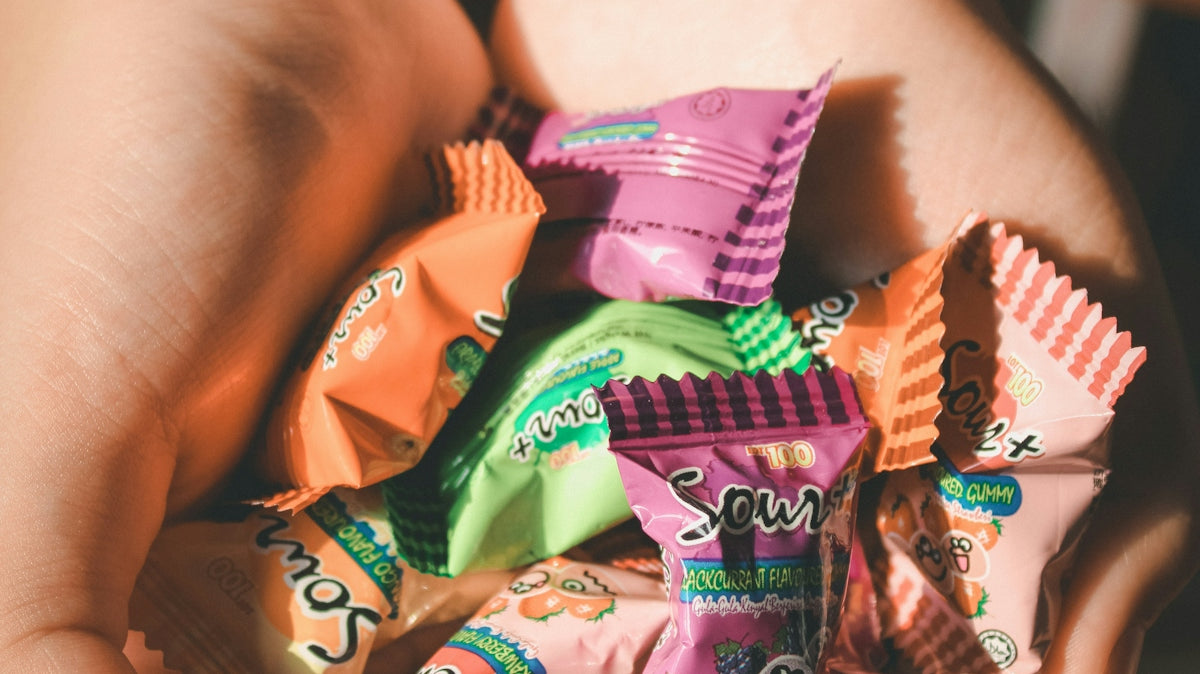 person holding packs of candy