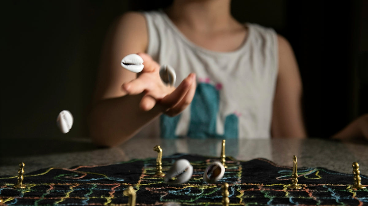 woman in teal scoop neck shirt playing chess