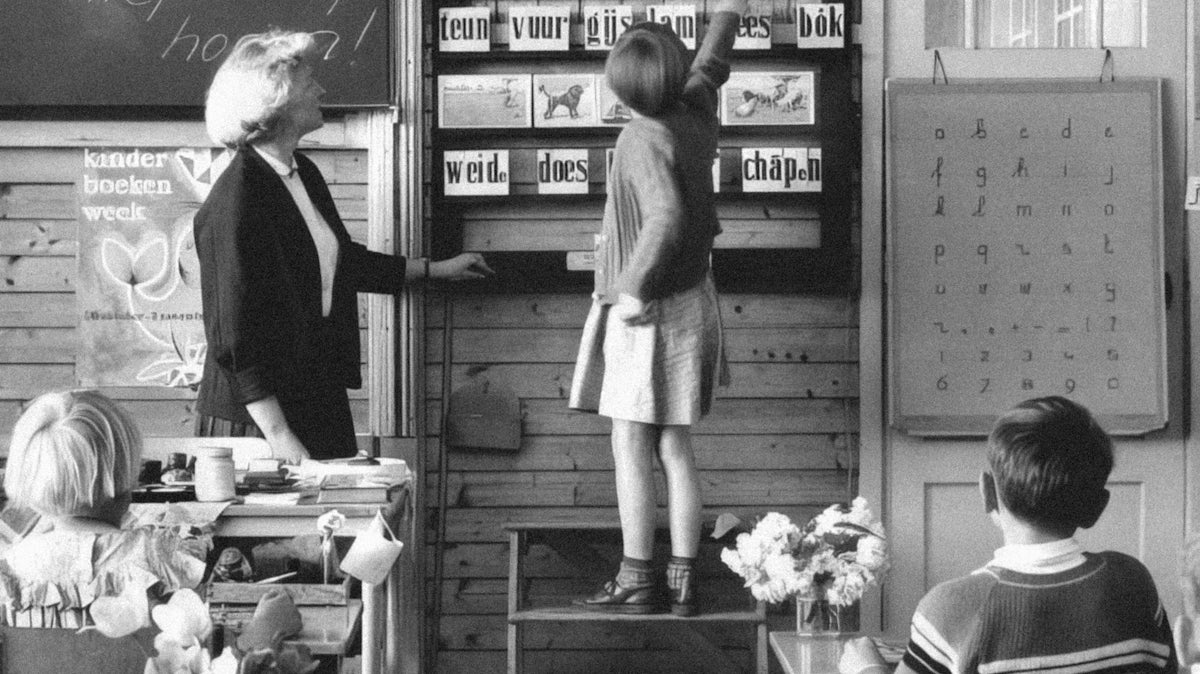 a black and white photo of children in a classroom
