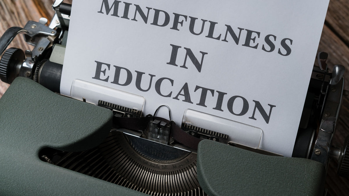 a close up of a typewriter with a paper that reads mindfulness in