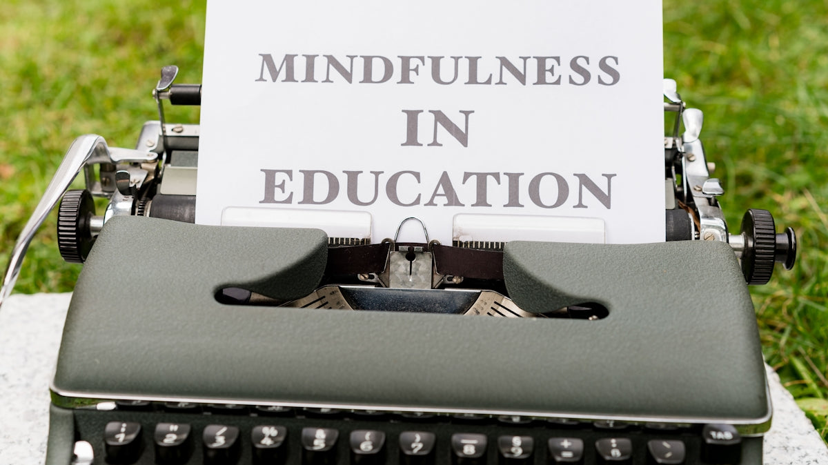 an old typewriter with a sign that says mindfulness in education