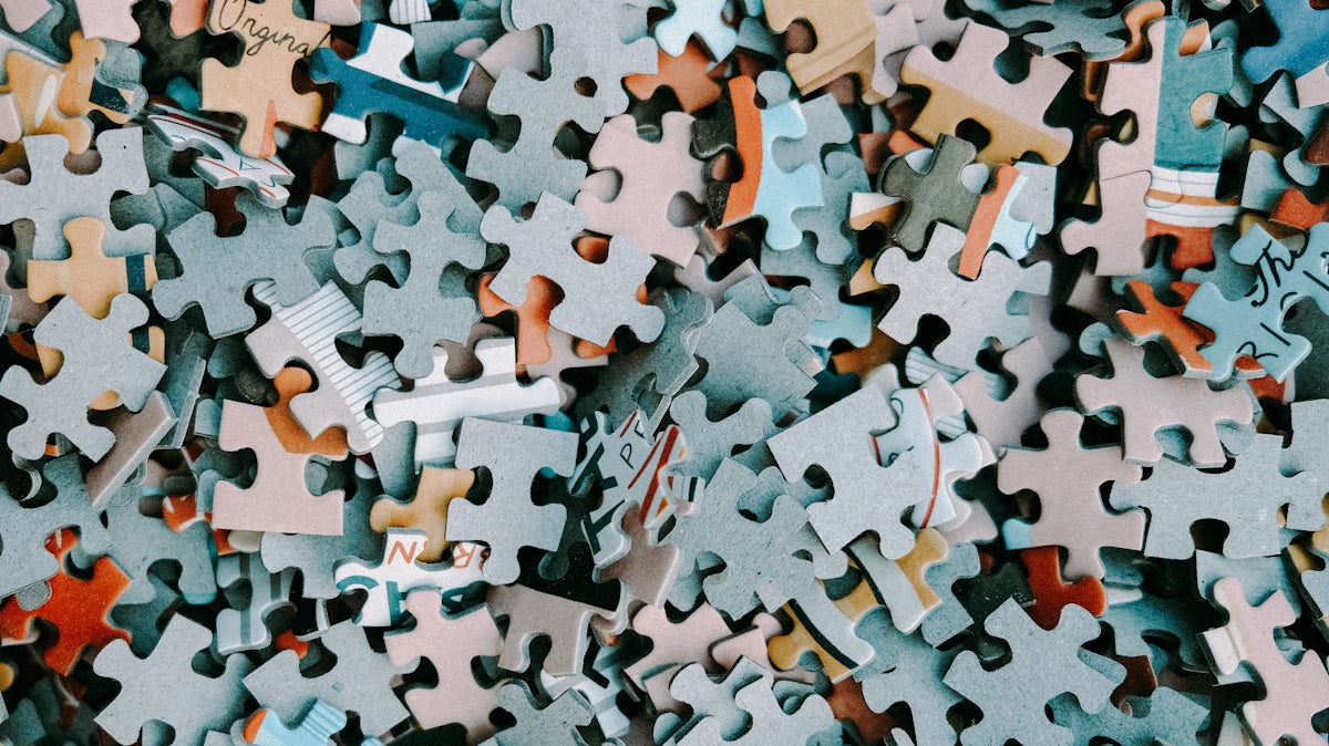 a pile of different colored puzzle pieces