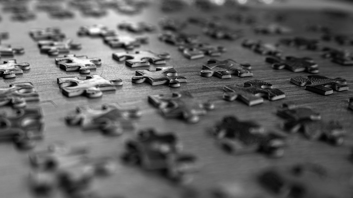 a close up of a puzzle board with many pieces missing