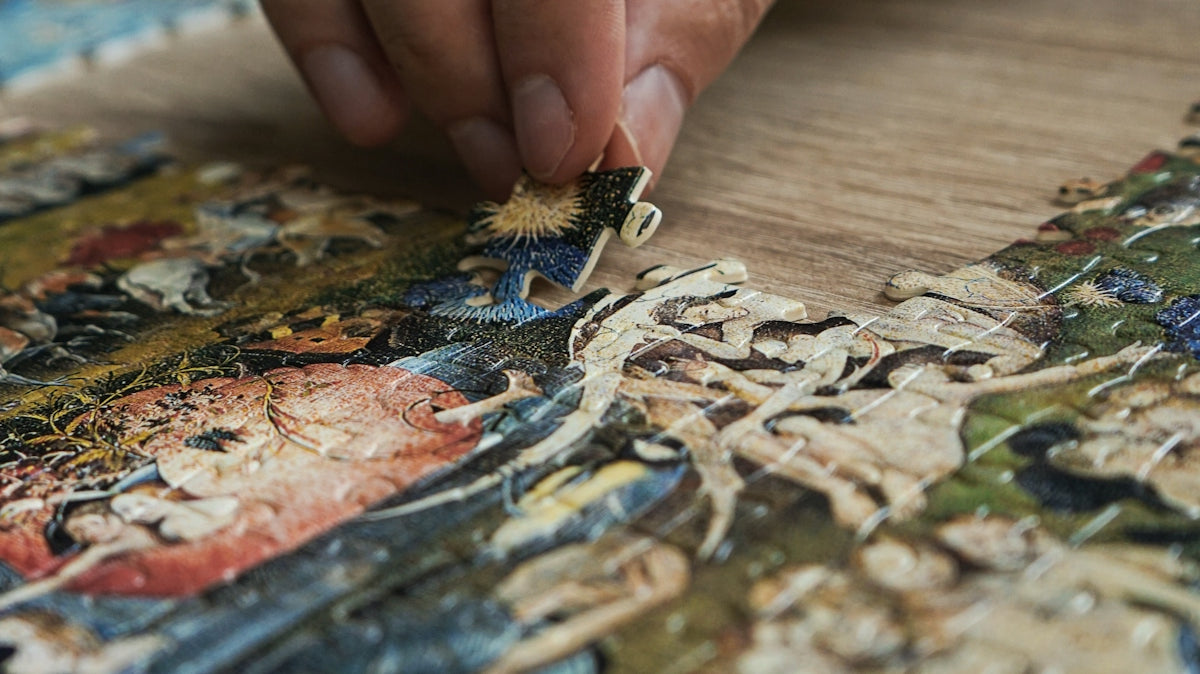 a close up of a person working on a piece of art