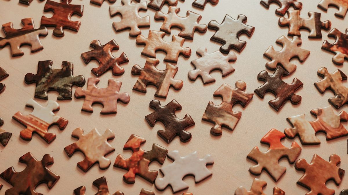 a large group of puzzle pieces sitting on top of a table