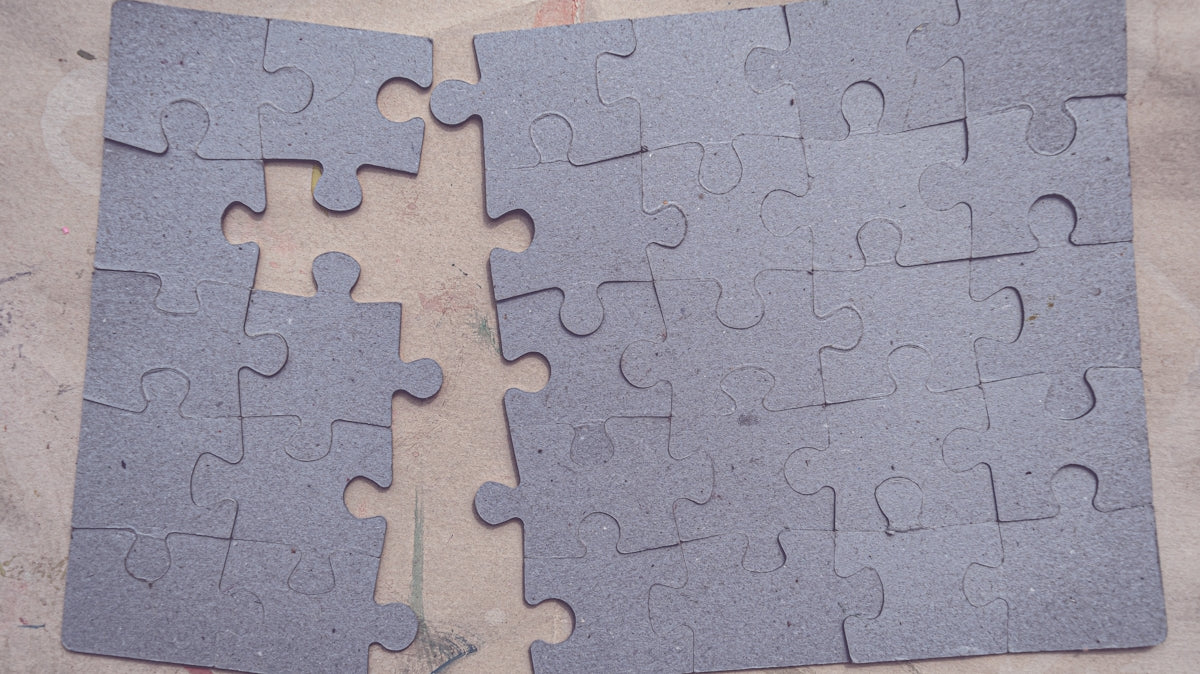 two pieces of a puzzle laying on top of each other