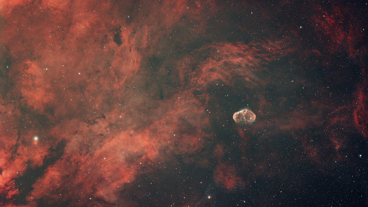 A spacecraft against a vibrant nebula