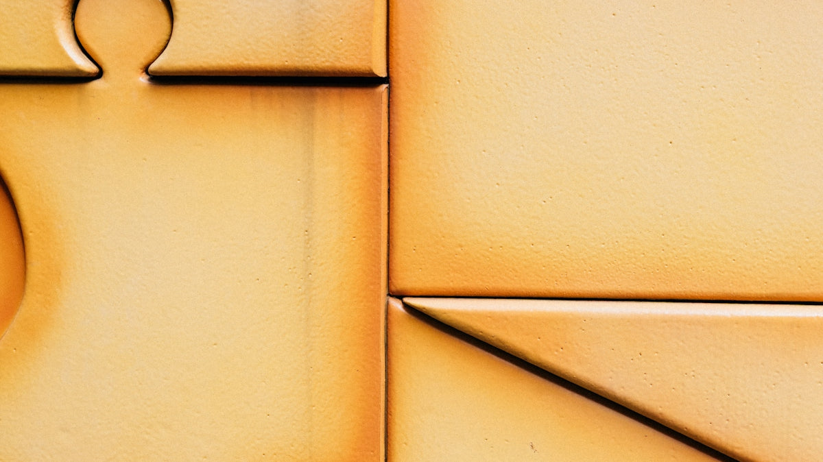 Close-up of interlocking puzzle pieces with warm lighting.