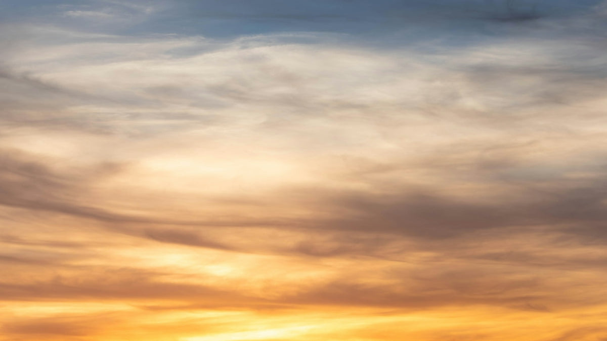 Silhouette of a person with arms outstretched at sunset