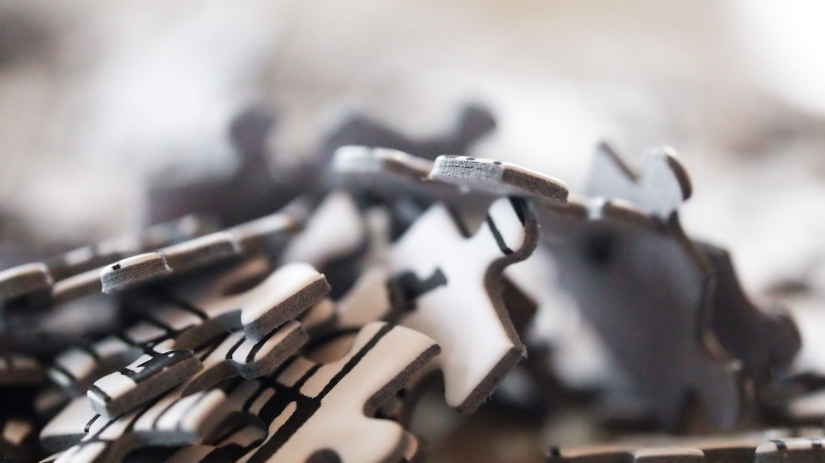 Scattered grey puzzle pieces.
