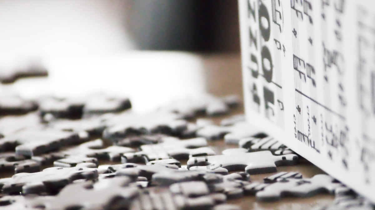 Scattered puzzle pieces and a standing puzzle box.