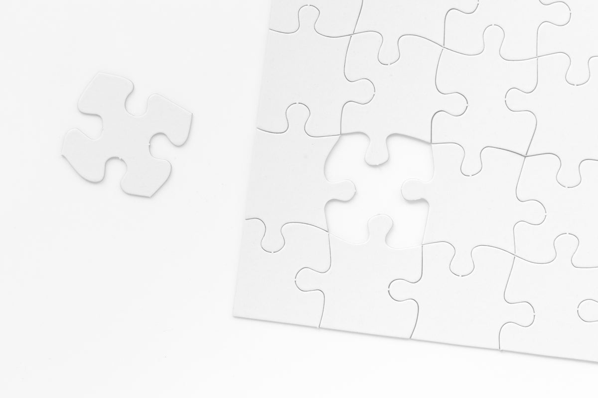 a piece of white puzzle sitting on top of a table