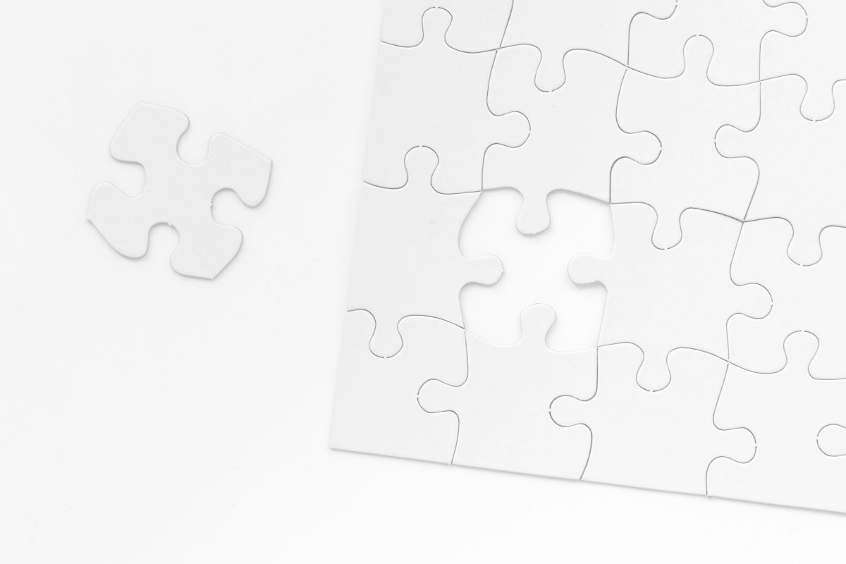 a piece of white puzzle sitting on top of a table