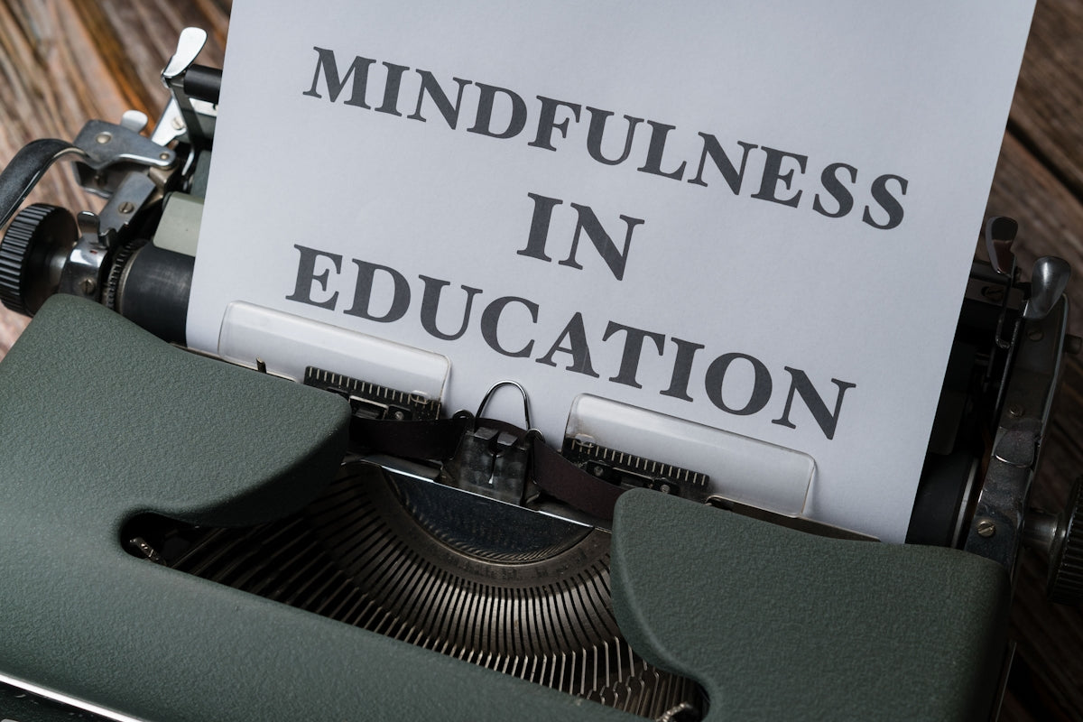 a close up of a typewriter with a paper that reads mindfulness in