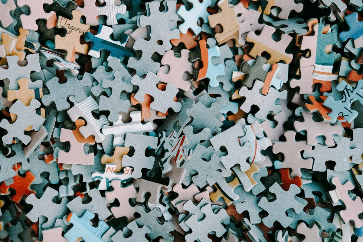 a pile of different colored puzzle pieces