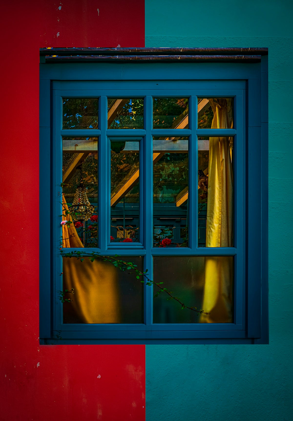 A blue window with a red wall in the background