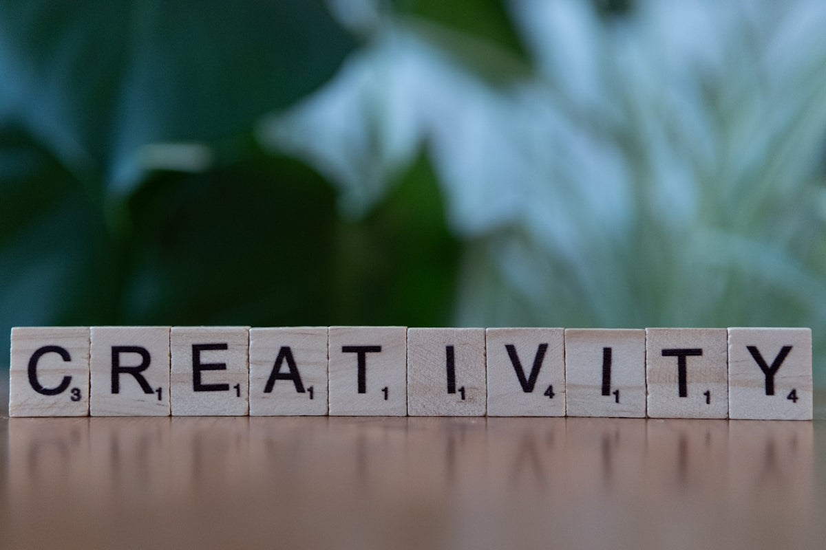 A wooden block that says creativity on it