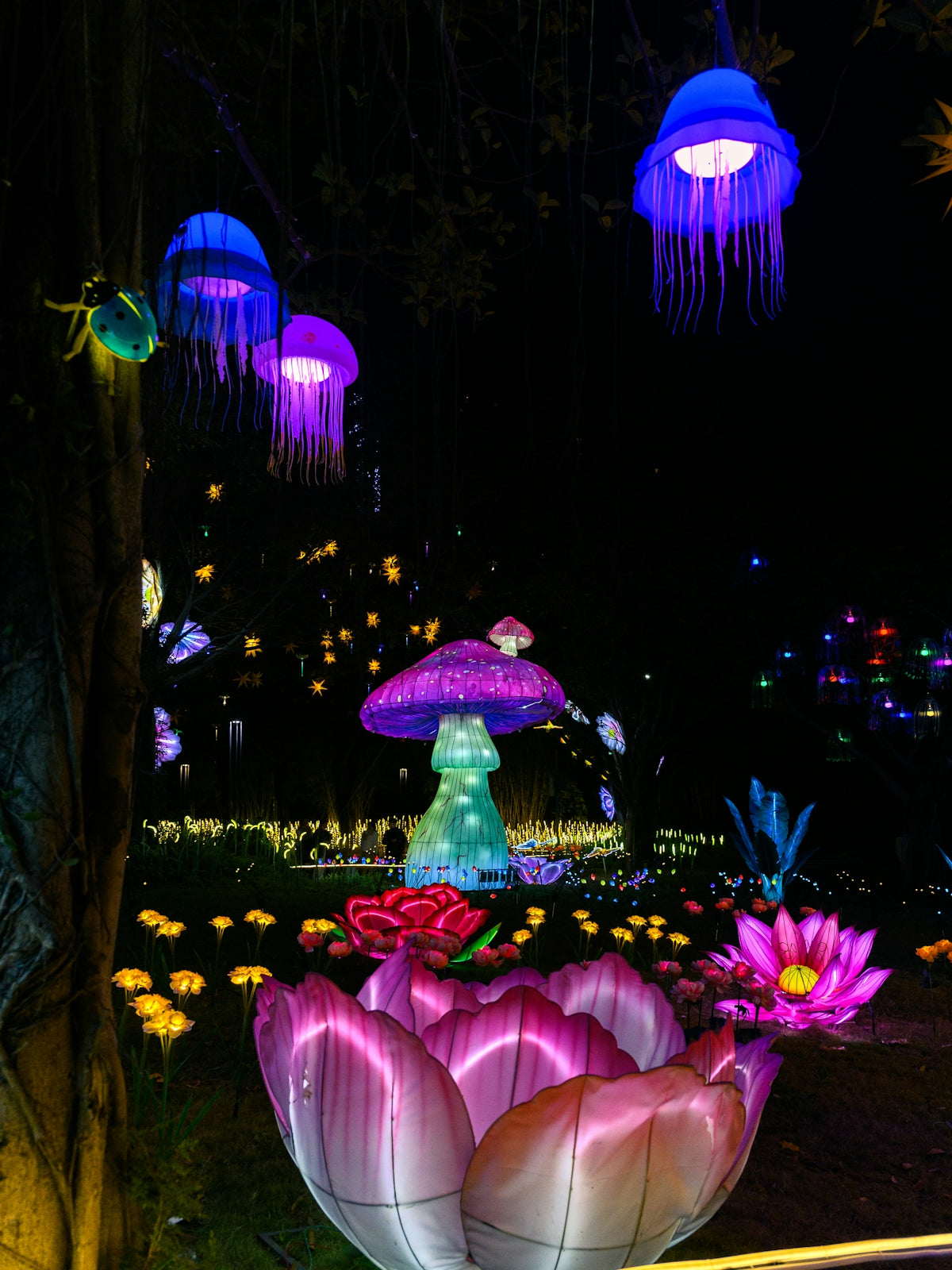 Glowing jellyfish and lotus lanterns in a dark garden
